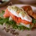 Mouthwatering croissant sandwich with fresh salmon, poached egg, and greens, perfect for brunch or lunch.